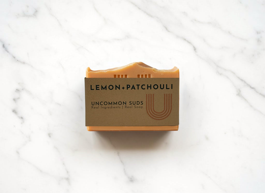 Front of Lemon Patchouli Soap Bar with Uncommon Suds Label